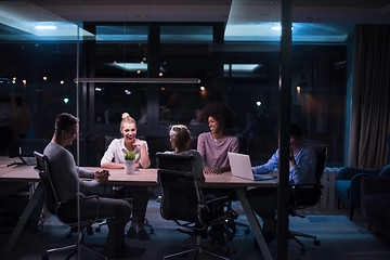 Image showing Multiethnic startup business team in night office