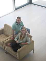 Image showing couple relaxing at  home with tablet computers