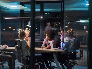 Image showing Multiethnic startup business team in night office