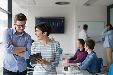 Image showing Two Business People Working With Tablet in office