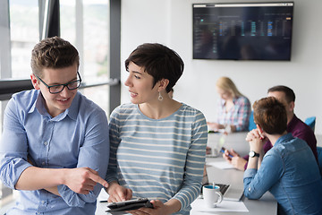 Image showing Two Business People Working With Tablet in office