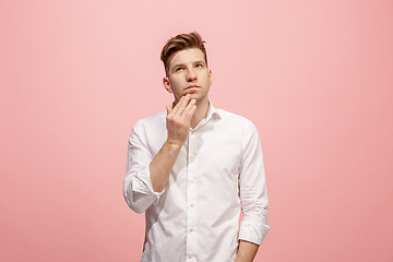 Image showing Young serious thoughtful businessman. Doubt concept.