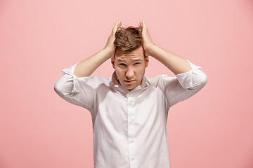 Image showing Man having headache. Isolated over pink background.