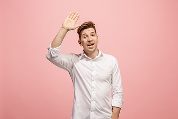 Image showing Isolated on pink young casual man shouting at studio