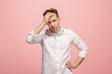 Image showing Man having headache. Isolated over pink background.