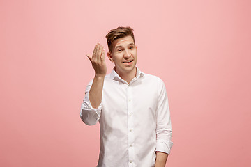 Image showing Isolated on pink young casual man shouting at studio