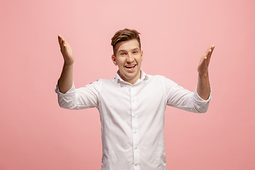 Image showing Isolated on pink young casual man shouting at studio