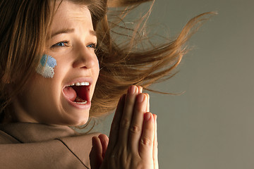 Image showing Portrait of a woman with the flag of the Argentina painted on her face.