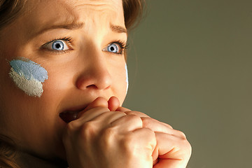 Image showing Portrait of a woman with the flag of the Argentina painted on her face.