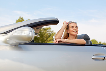 Image showing happy young woman in convertible car