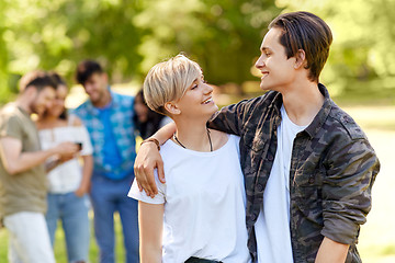 Image showing happy teenage couple hugging at summer park