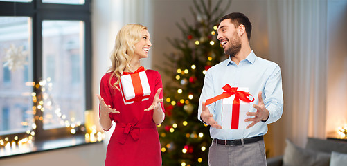 Image showing happy couple with christmas gifts at home