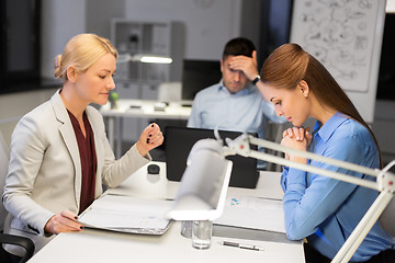 Image showing business team with laptop working late at office