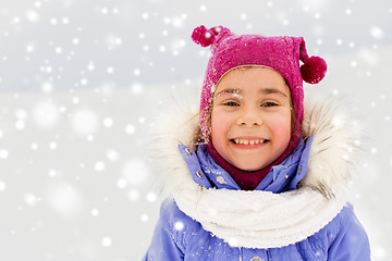 Image showing happy little girl in winter clothes outdoors