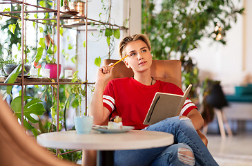 Image showing teenage girl with notebook at coffee shop or cafe