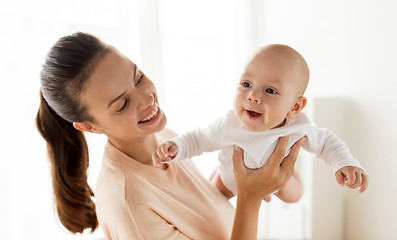 Image showing happy mother playing with little baby boy at home