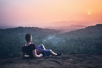 Image showing Man contemplation on top of rock