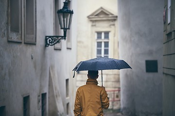 Image showing Lonely man with umbrella in rain