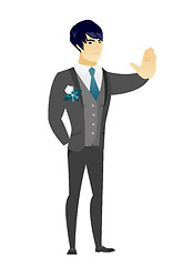 Image showing Asian groom showing stop hand gesture.