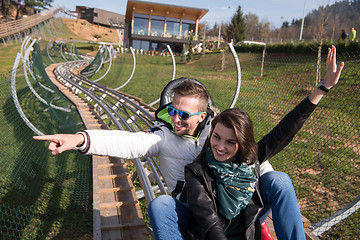 Image showing couple enjoys driving on alpine coaster