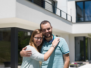 Image showing couple hugging in front of  new luxury home