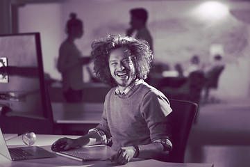 Image showing man working on computer in dark office