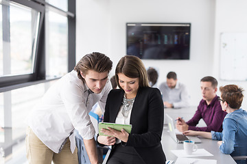 Image showing Two Business People Working With Tablet in office