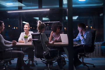 Image showing Multiethnic startup business team in night office