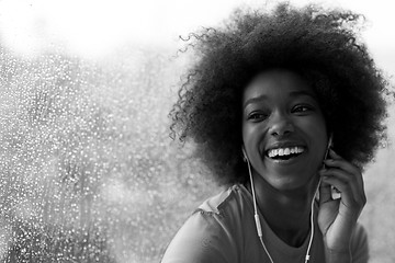 Image showing portrait of young afro american woman in gym while listening mus