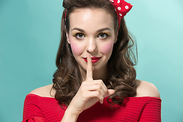 Image showing Beautiful young woman with pinup make-up and hairstyle. Studio shot on white background
