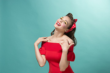 Image showing Beautiful young woman with pinup make-up and hairstyle. Studio shot on white background