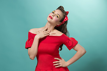 Image showing Beautiful young woman with pinup make-up and hairstyle. Studio shot on white background