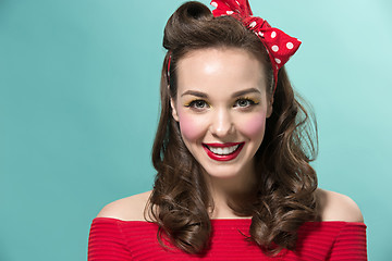 Image showing Beautiful young woman with pinup make-up and hairstyle. Studio shot on white background