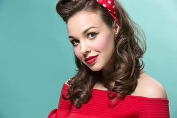 Image showing Beautiful young woman with pinup make-up and hairstyle. Studio shot on white background