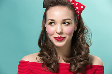 Image showing Beautiful young woman with pinup make-up and hairstyle. Studio shot on white background