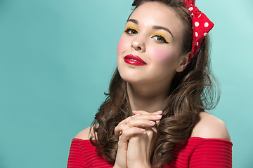 Image showing Beautiful young woman with pinup make-up and hairstyle. Studio shot on white background