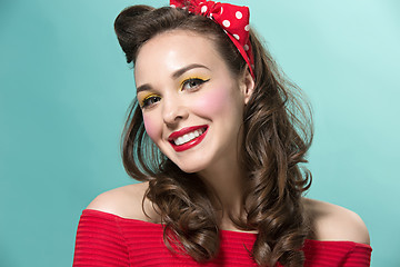 Image showing Beautiful young woman with pinup make-up and hairstyle. Studio shot on white background