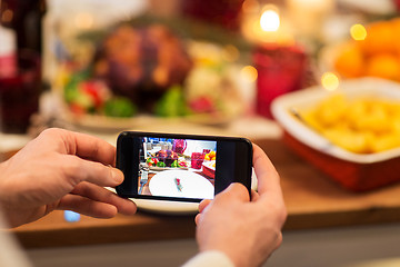 Image showing hands photographing food at christmas dinner