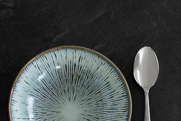 Image showing close up of ceramic plate and spoon on table