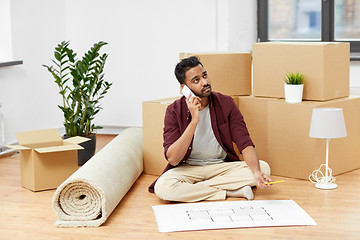 Image showing man with blueprint and boxes moving to new home