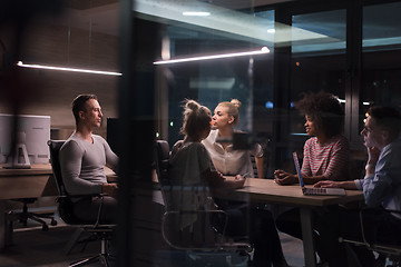 Image showing Multiethnic startup business team in night office