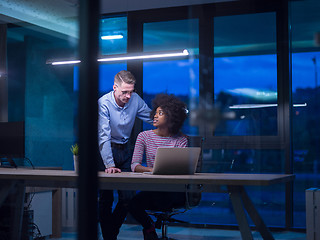 Image showing Multiethnic startup business team in night office