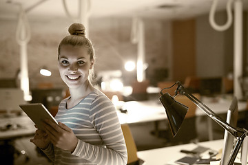 Image showing woman working on digital tablet in night office