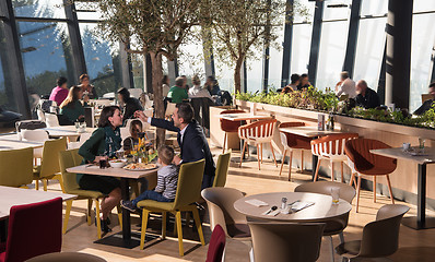 Image showing Young parents enjoying lunch time with their children