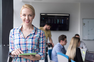 Image showing Pretty Businesswoman Using Tablet In Office Building by window