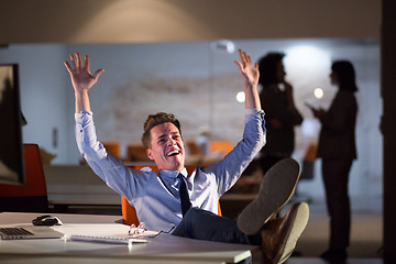 Image showing businessman sitting with legs on desk at office