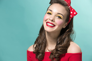 Image showing Beautiful young woman with pinup make-up and hairstyle. Studio shot on white background