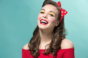 Image showing Beautiful young woman with pinup make-up and hairstyle. Studio shot on white background