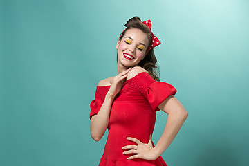 Image showing Beautiful young woman with pinup make-up and hairstyle. Studio shot on white background