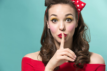 Image showing Beautiful young woman with pinup make-up and hairstyle. Studio shot on white background